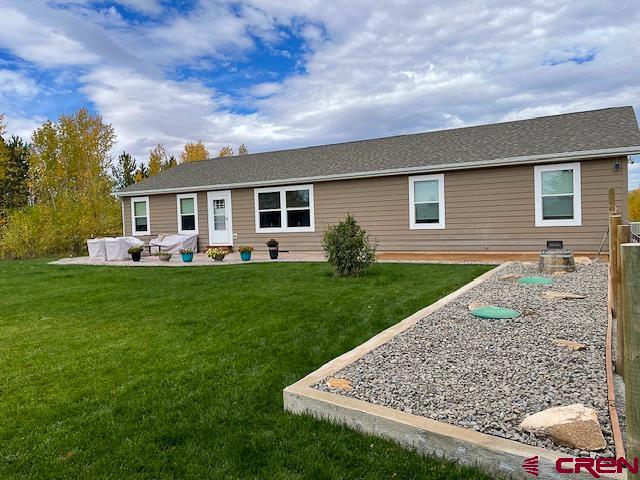 55339 Begonia Road Delta, CO 81416 - Photo 17 of 34 a front view of house with yard and green space