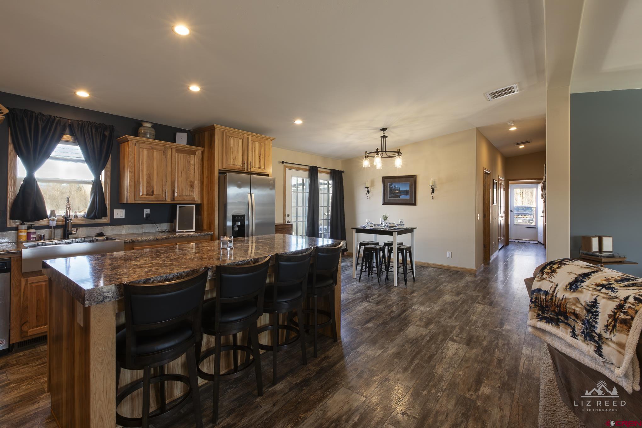 55339 Begonia Road Delta, CO 81416 - Photo 29 of 34 a kitchen with granite countertop kitchen island stainless steel appliances a table and chairs in it