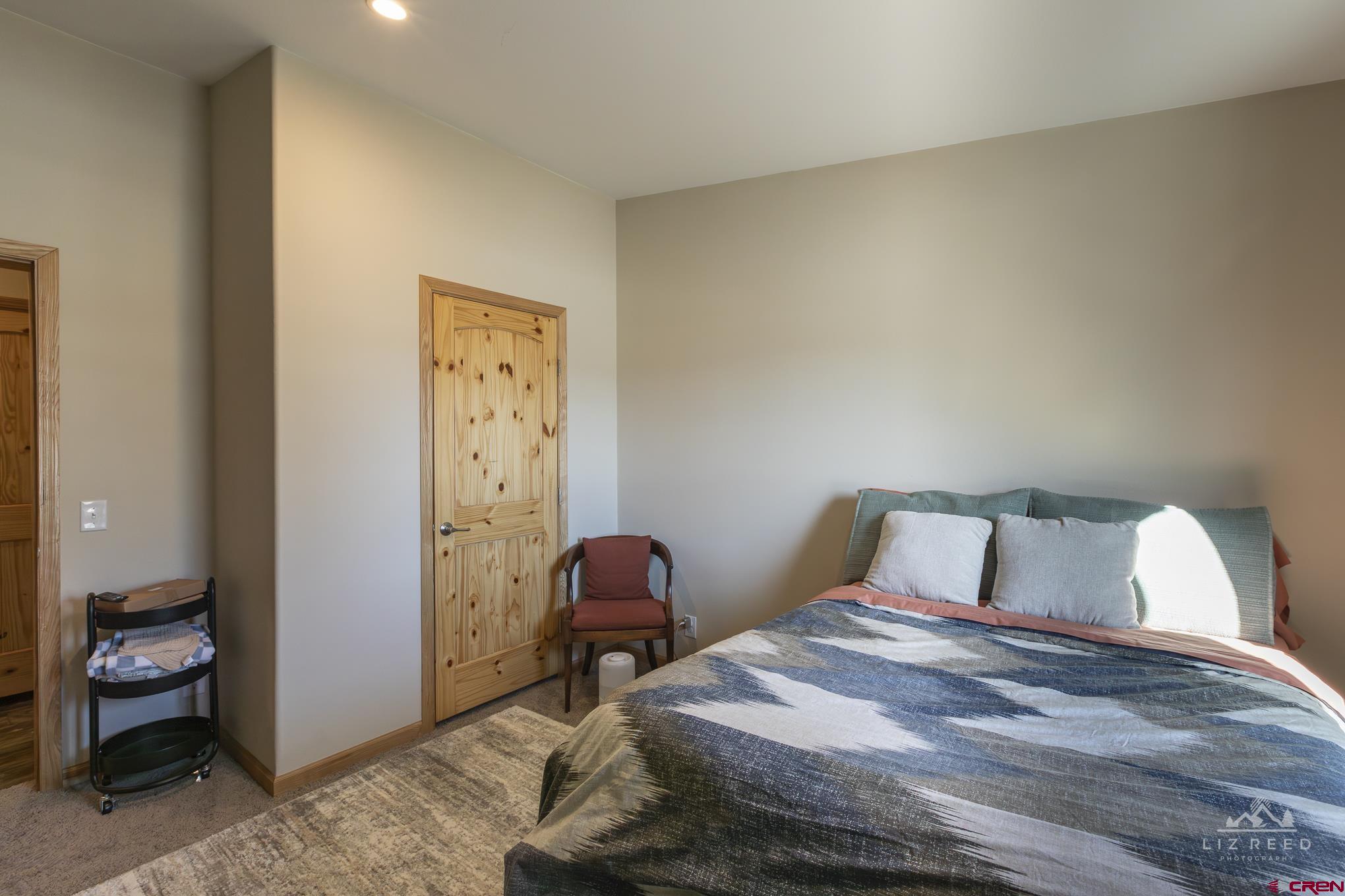 55339 Begonia Road Delta, CO 81416 - Photo 34 of 34 a bedroom with a bed and wooden floor