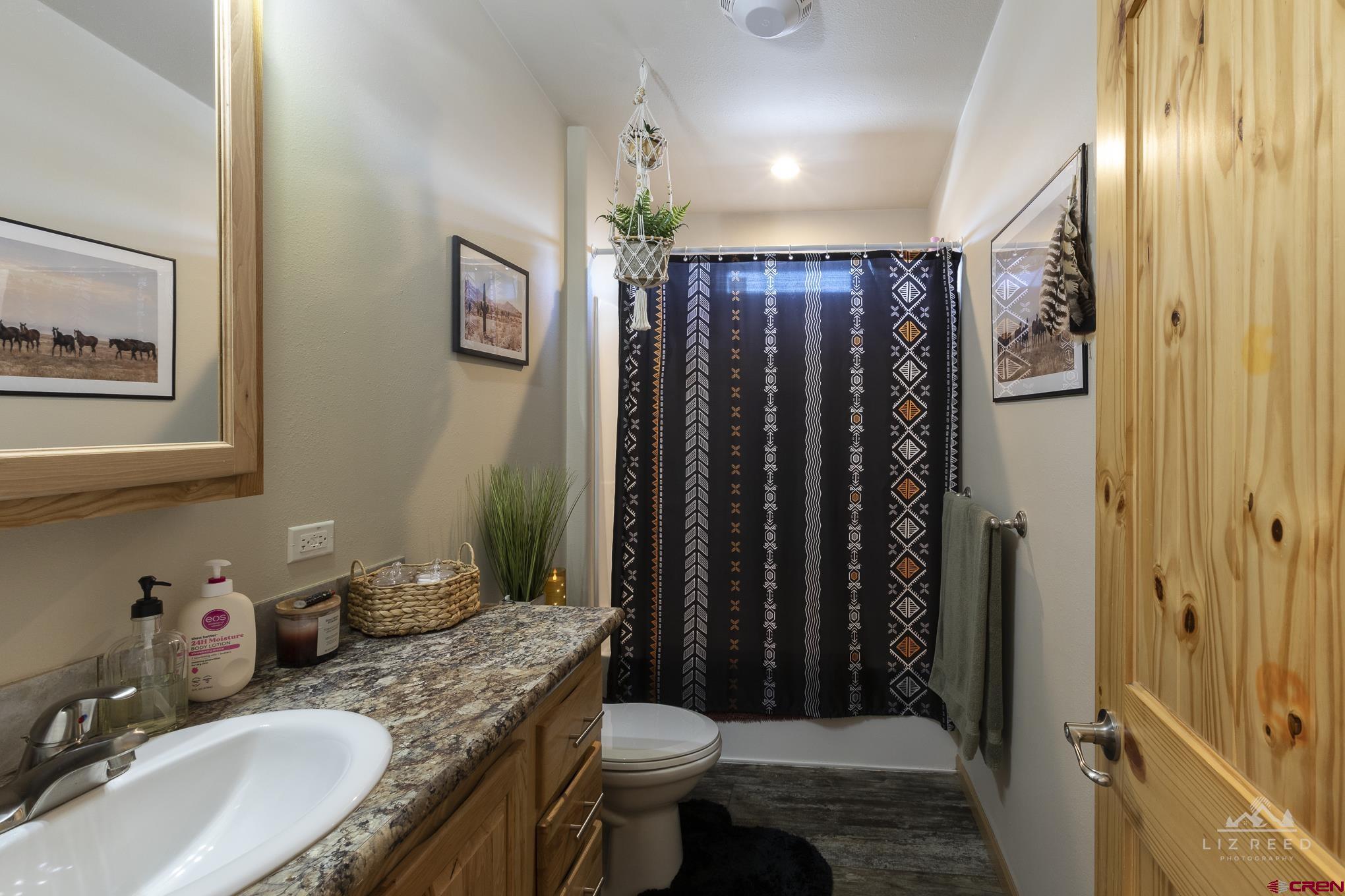 55339 Begonia Road Delta, CO 81416 - Photo 9 of 34 a bathroom with a granite countertop sink toilet and shower