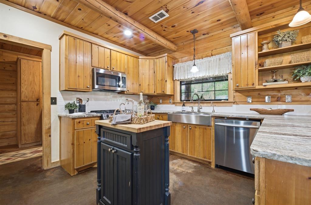 465 Emberson Ranch Road Pilot Point, TX 76258 - Photo 10 of 40 a kitchen with stainless steel appliances granite countertop a sink stove and refrigerator