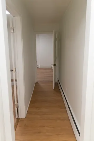 a view of an empty room and wooden floor