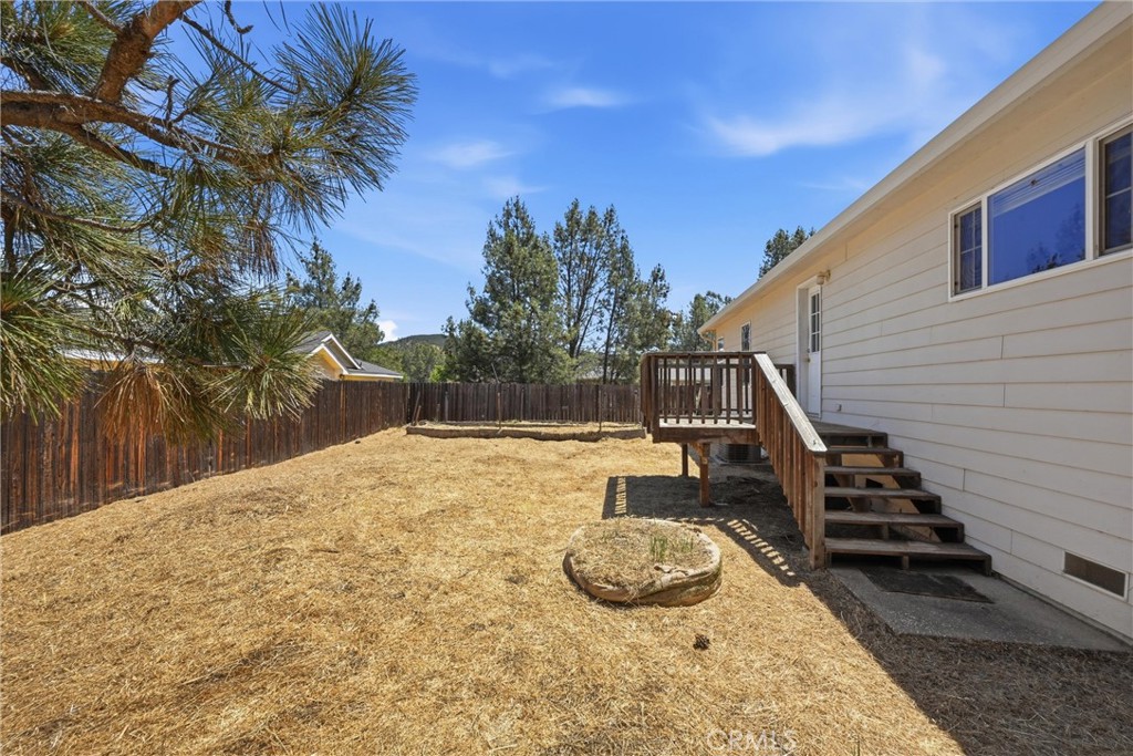 2860 Spring Valley Road Clearlake Oaks, CA 95423 - Photo 33 of 38 a backyard of a house with table and chairs