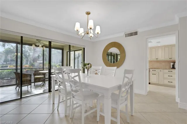 a view of a dining room with furniture a chandelier and wooden floor
