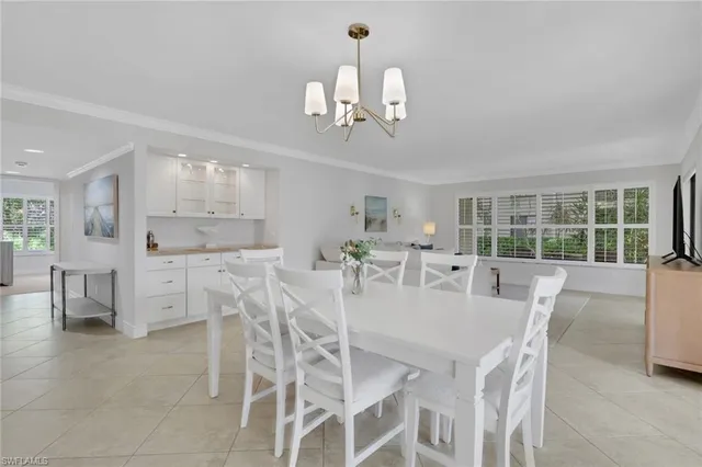 a dining room with furniture a window and a chandelier