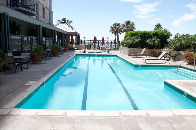 a view of a house with a swimming pool and sitting area
