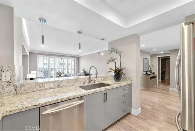 a kitchen with sink and mirror