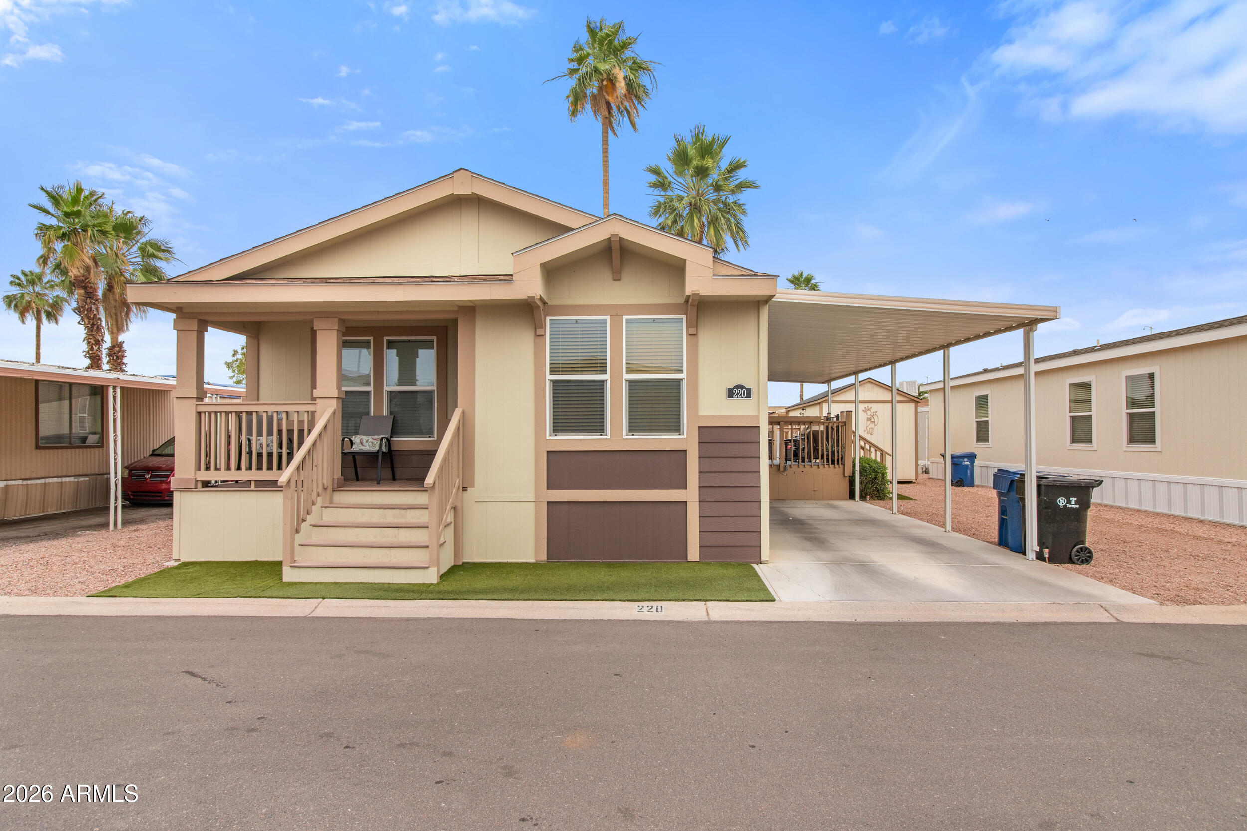 400 West Baseline Road, Unit 220 Tempe, AZ 85283 - Photo 28 of 52 a front view of a house with a yard and garage