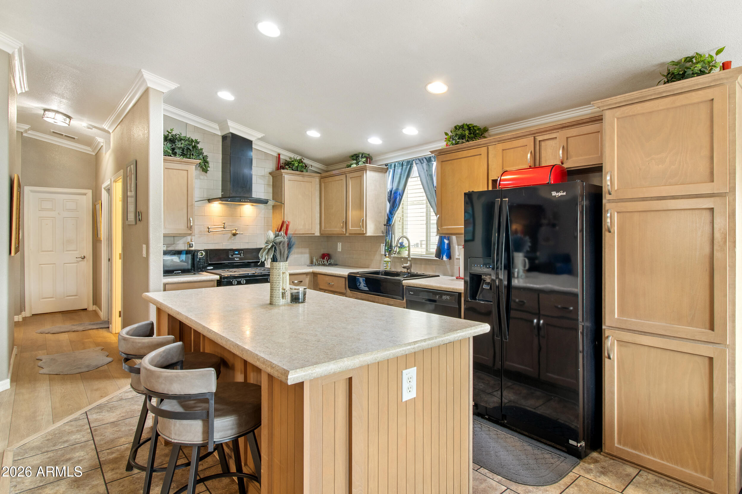 400 West Baseline Road, Unit 220 Tempe, AZ 85283 - Photo 6 of 52 a kitchen with a refrigerator a stove and a dining table with wooden floor