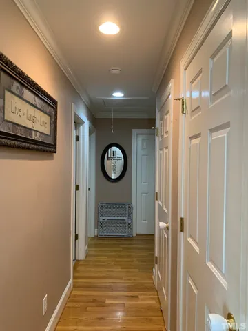 a view of a hallway with wooden floor
