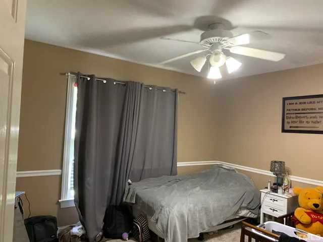 a bedroom with a bed and a chandelier