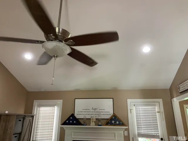 a view of a chandelier fan and wooden floor
