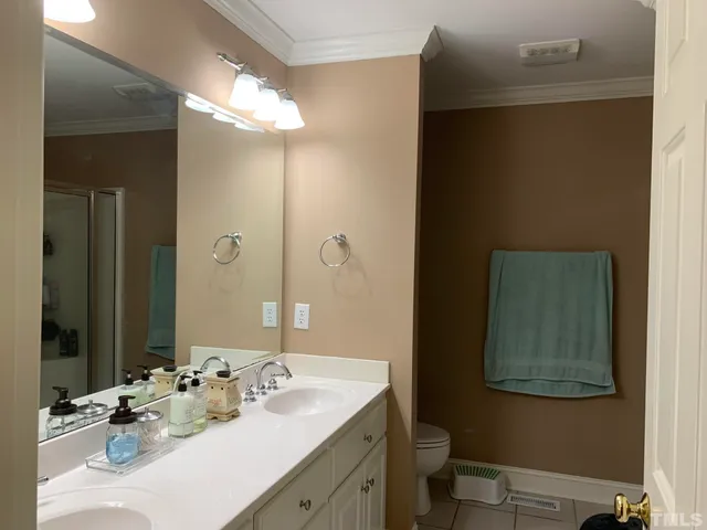 a bathroom with a double vanity sink and a mirror