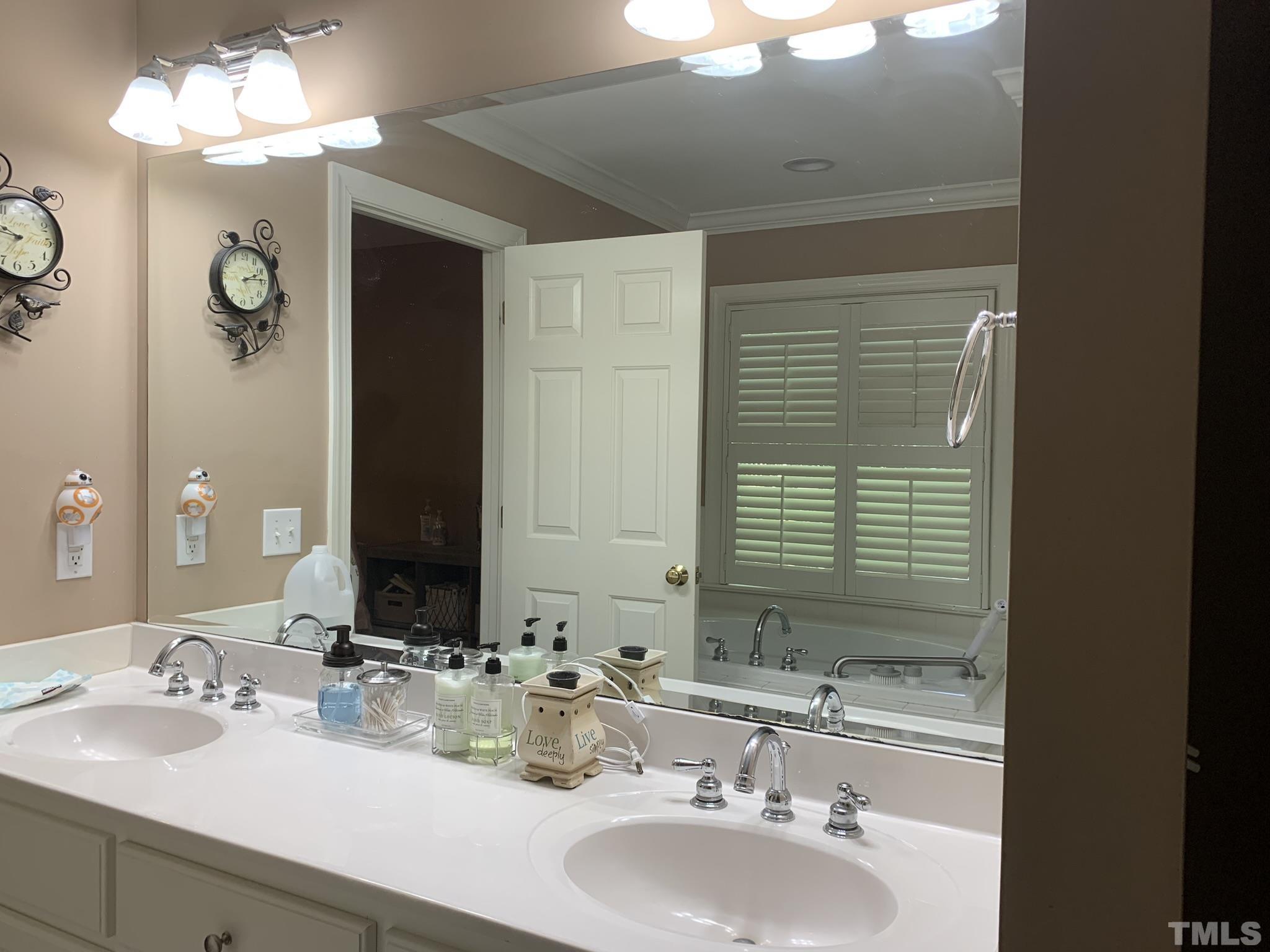 102 Younger Road Roxboro, NC 27573 - Photo 7 of 16 a bathroom with double vanity sinks and a mirror
