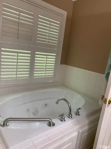 a bathroom with a bathtub and a window