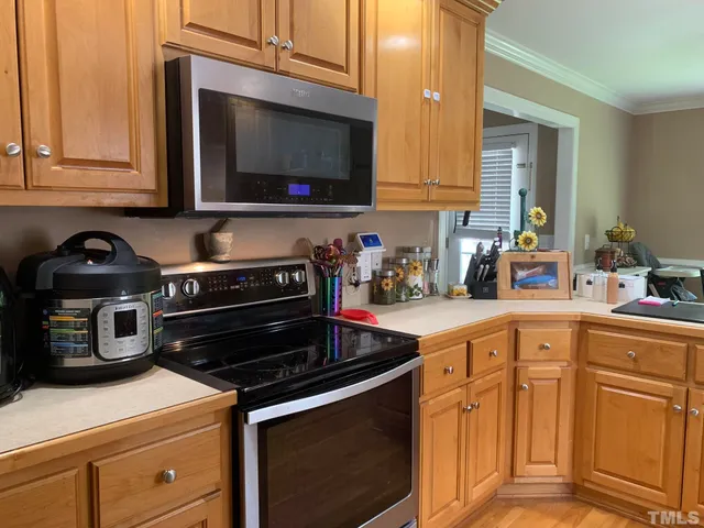 a kitchen with stainless steel appliances granite countertop a stove and a microwave