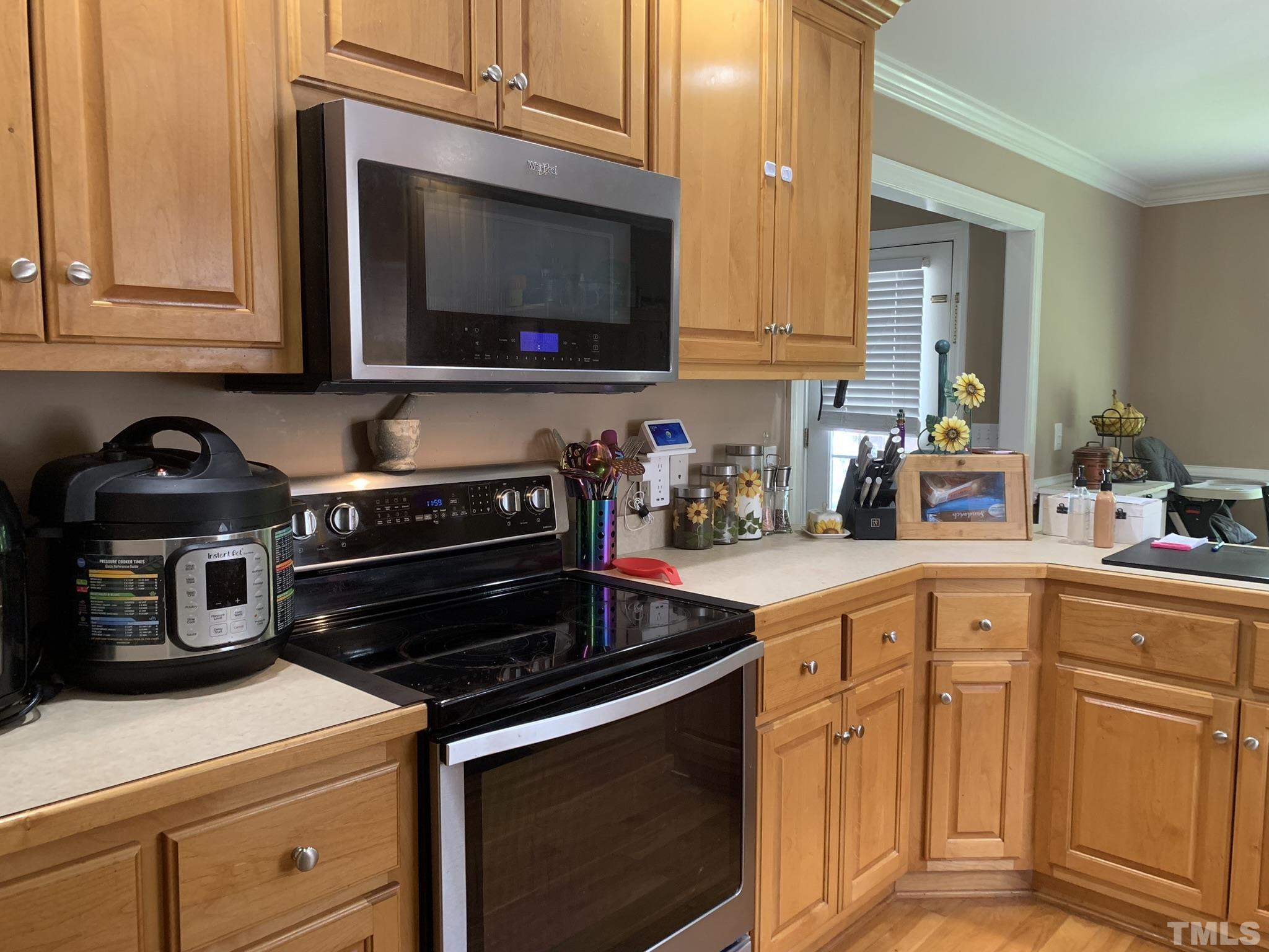 102 Younger Road Roxboro, NC 27573 - Photo 10 of 16 a kitchen with stainless steel appliances granite countertop a stove and a microwave
