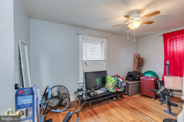 a room with furniture and a chandelier fan