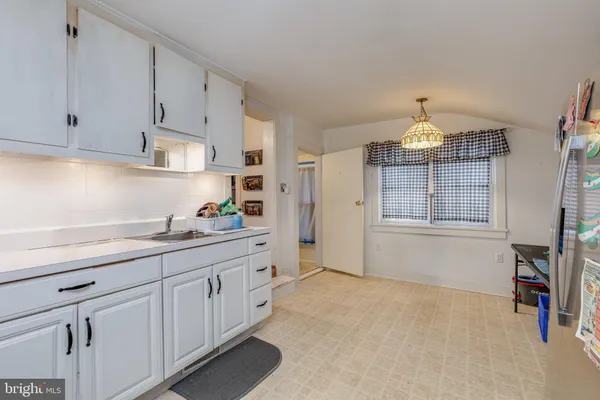 a kitchen with cabinets and window
