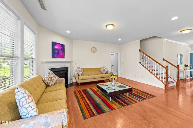 a living room with furniture fireplace and a table