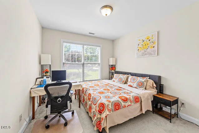 a bedroom with a bed and a desk