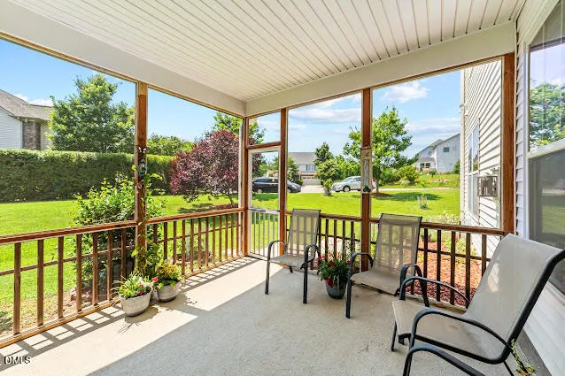 a view of a porch with furniture and garden