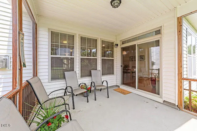 a view of a patio with glass top table and chairs