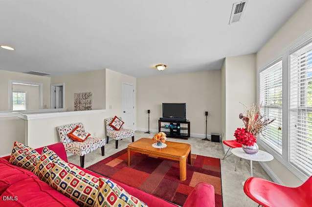 a bedroom with furniture and a flat screen tv