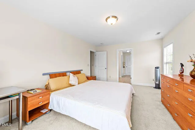 a bedroom with a bed and a dresser