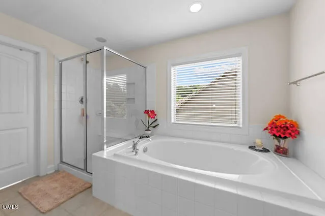 a bathroom with a tub and shower