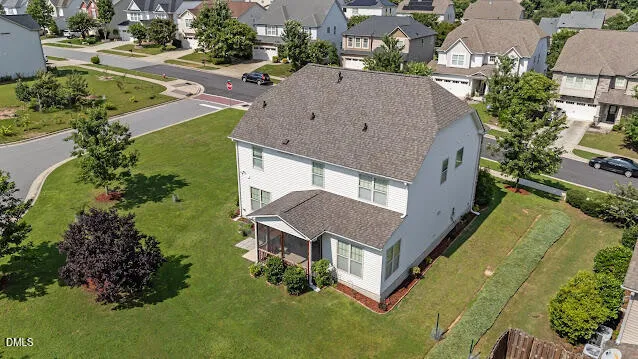 an aerial view of a house with a garden and trees