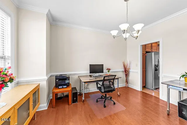 a view of a workspace with furniture and a bathroom