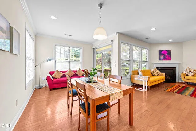 a living room with furniture a flat screen tv and a large window