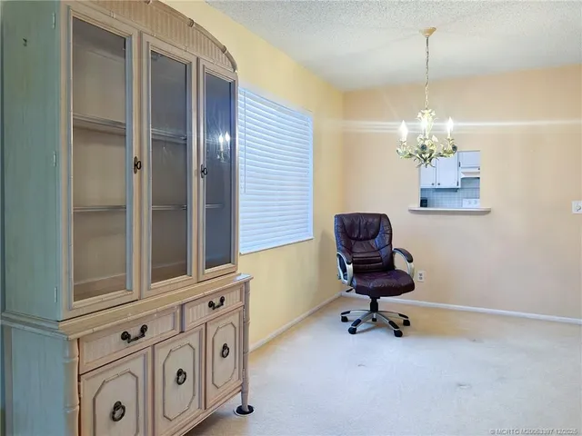 a workspace with chandelier and window