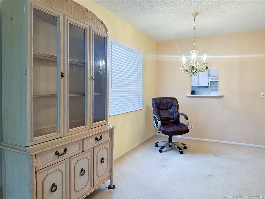 2600 Southeast Ocean Boulevard, Unit II1 Stuart, FL 34996 - Photo 12 of 38 a workspace with chandelier and window