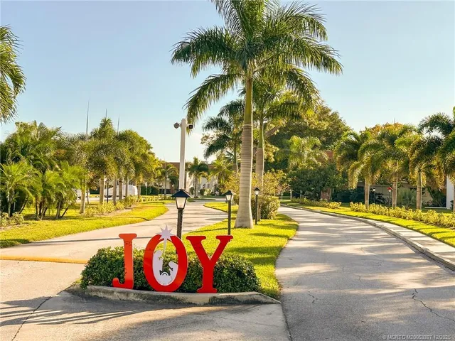 a view of swimming pool with palm trees