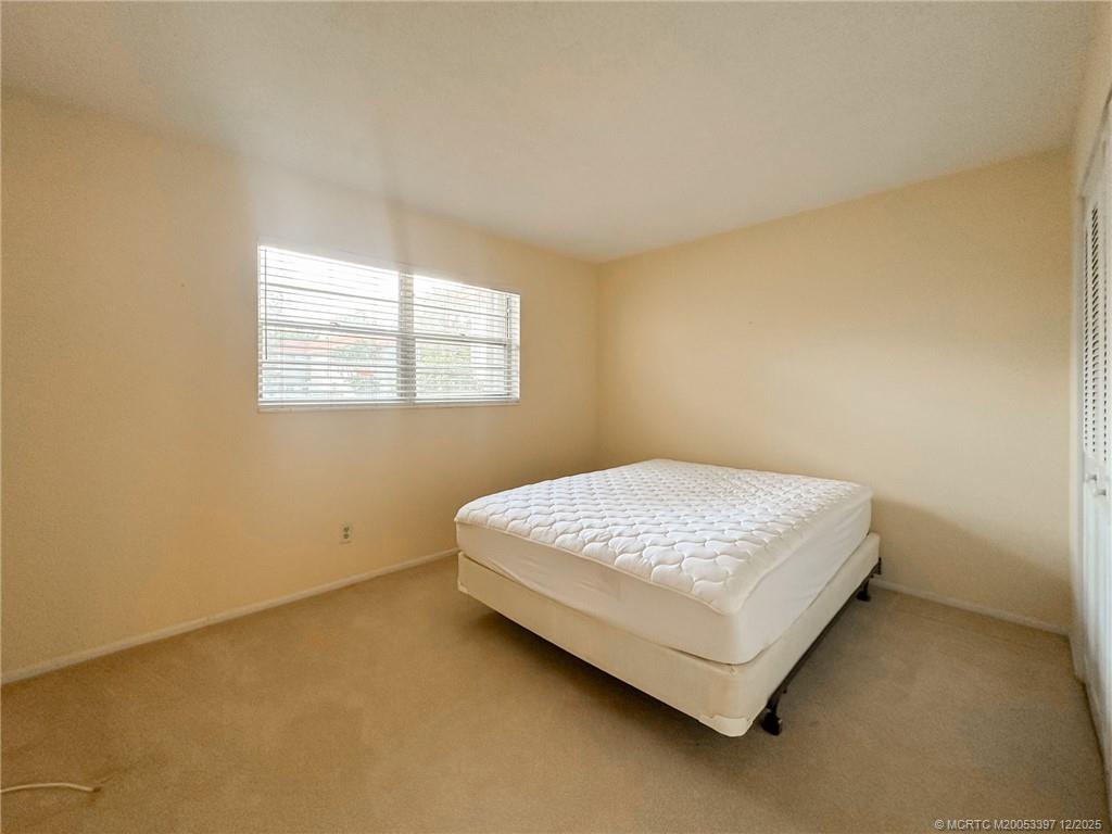 2600 Southeast Ocean Boulevard, Unit II1 Stuart, FL 34996 - Photo 22 of 38 a bed sitting in a bedroom next to a window