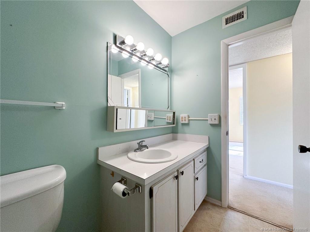 2600 Southeast Ocean Boulevard, Unit II1 Stuart, FL 34996 - Photo 24 of 38 a bathroom with a sink and a toilet