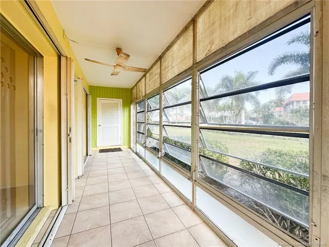 a view of a porch with wooden floor and furniture