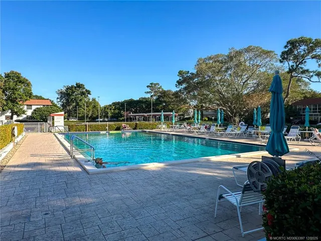 a view of swimming pool with a yard and sitting area