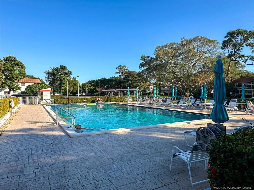 2600 Southeast Ocean Boulevard, Unit II1 Stuart, FL 34996 - Photo 32 of 38 a view of swimming pool with a yard and sitting area