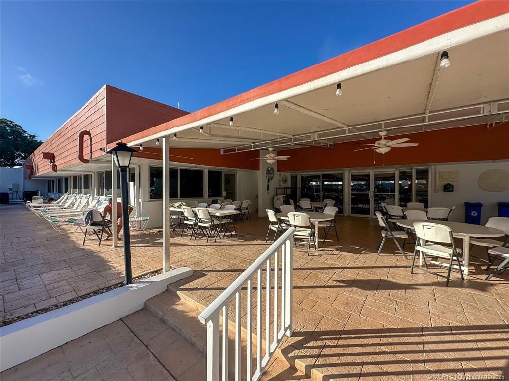 2600 Southeast Ocean Boulevard, Unit II1 Stuart, FL 34996 - Photo 34 of 38 a view of a patio with table and chairs under an umbrella