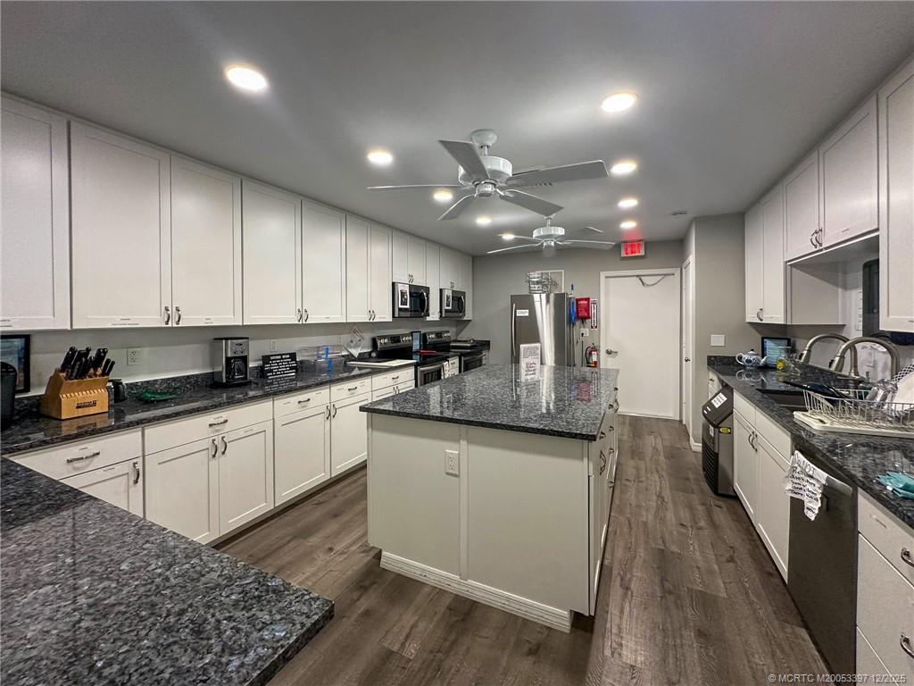 2600 Southeast Ocean Boulevard, Unit II1 Stuart, FL 34996 - Photo 36 of 38 a kitchen with stainless steel appliances granite countertop a sink a stove and cabinets
