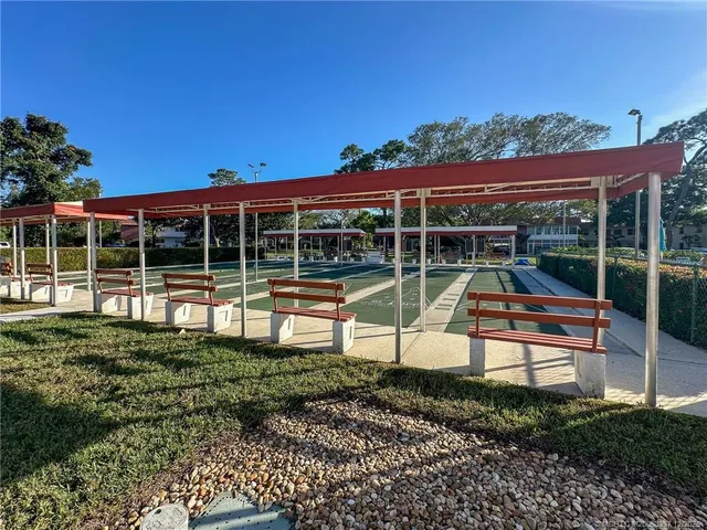 a view of a sitting area with a bench in front of a house