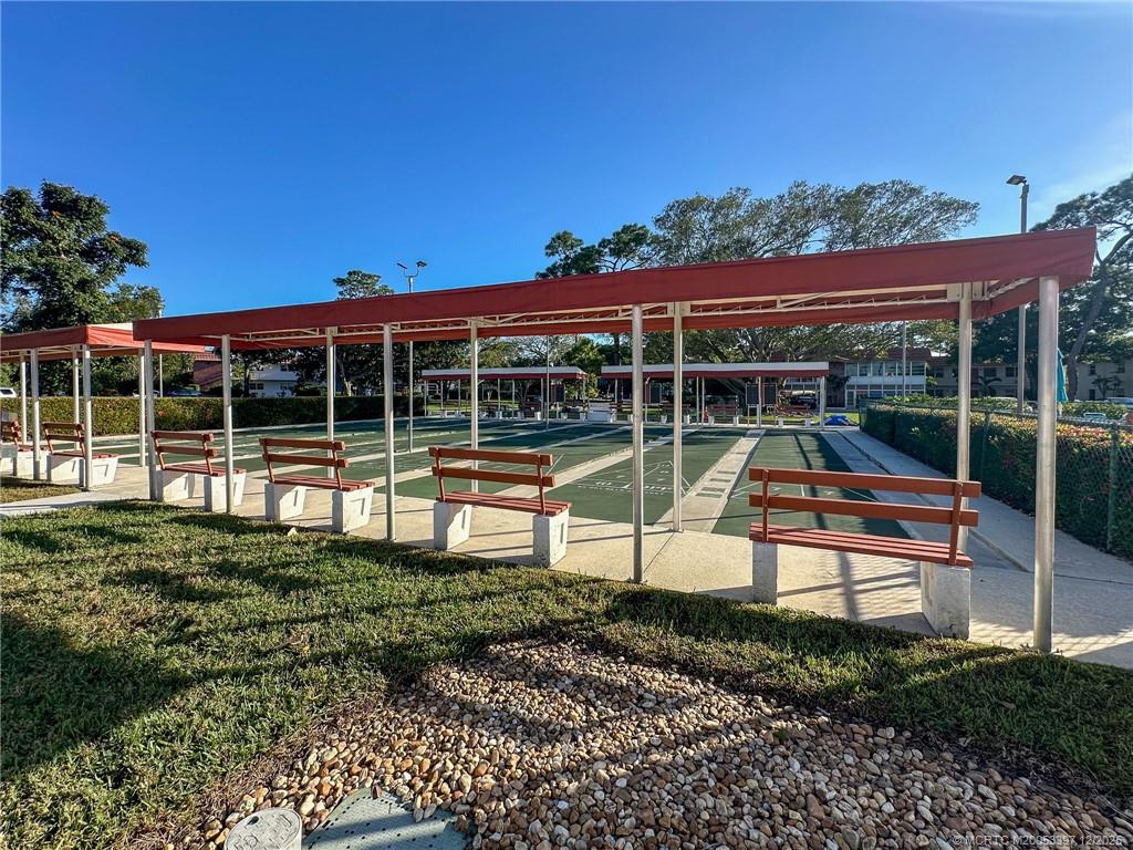 2600 Southeast Ocean Boulevard, Unit II1 Stuart, FL 34996 - Photo 38 of 38 a view of a sitting area with a bench in front of a house