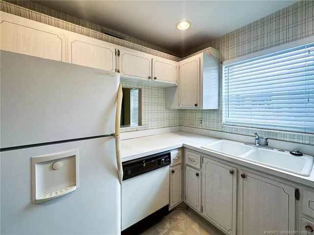a kitchen with a sink and white cabinets