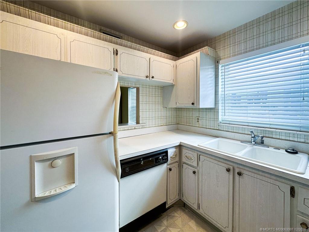 2600 Southeast Ocean Boulevard, Unit II1 Stuart, FL 34996 - Photo 8 of 38 a kitchen with a sink and white cabinets
