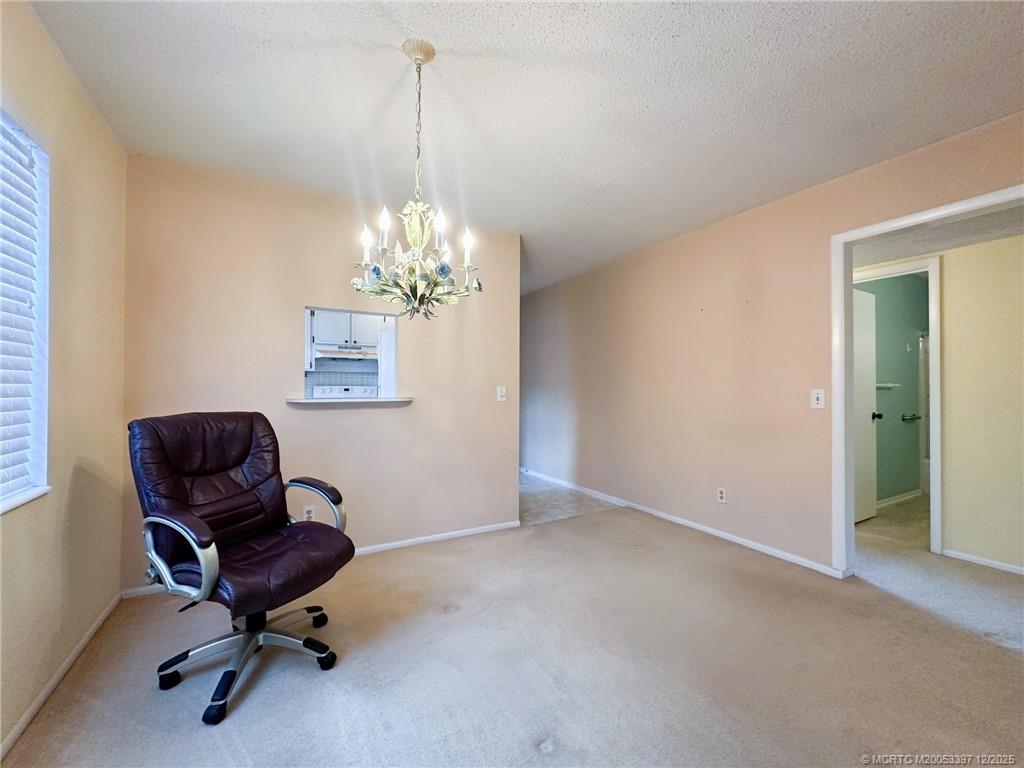 2600 Southeast Ocean Boulevard, Unit II1 Stuart, FL 34996 - Photo 10 of 38 a view of a chandelier and a workspace