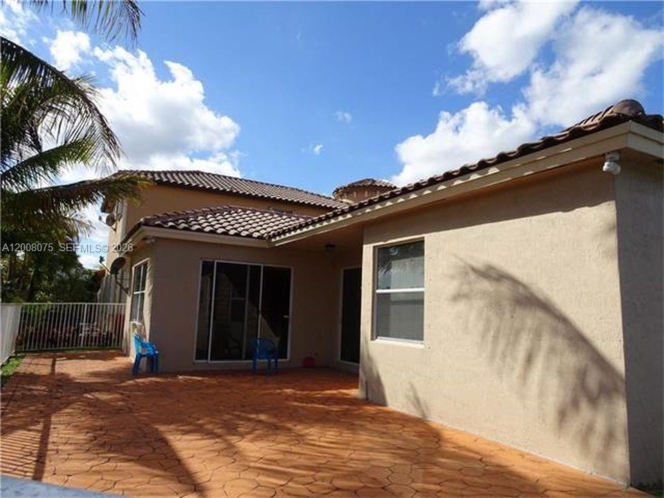12830 Southwest 51st Street Miramar, FL 33027 - Photo 5 of 7 a view of a house with a patio
