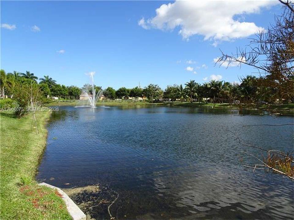 12830 Southwest 51st Street Miramar, FL 33027 - Photo 7 of 7 a view of a lake with houses in the back
